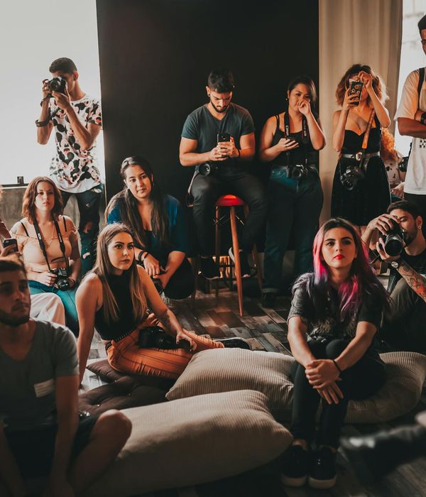 Group of diverse people practicing yoga together in a bright studio.